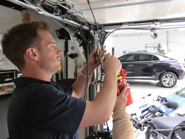 Dartmouth Garage Door Repair safety certified technician performing cable replacement in Dartmouth