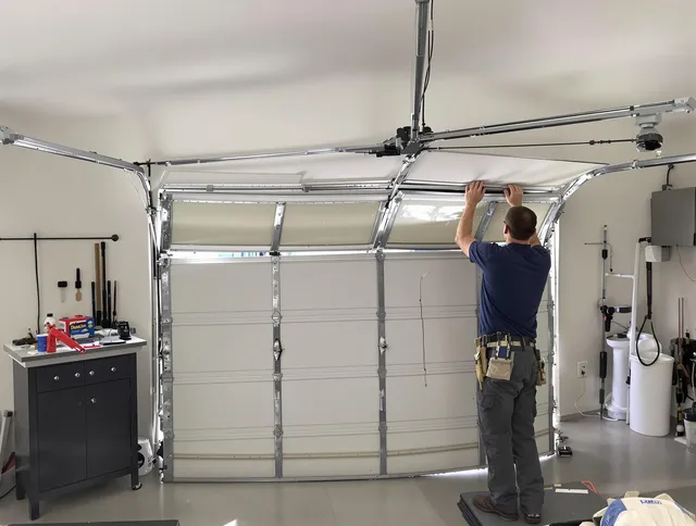 Dartmouth Garage Door Repair specialist performing precise section replacement on Dartmouth garage door